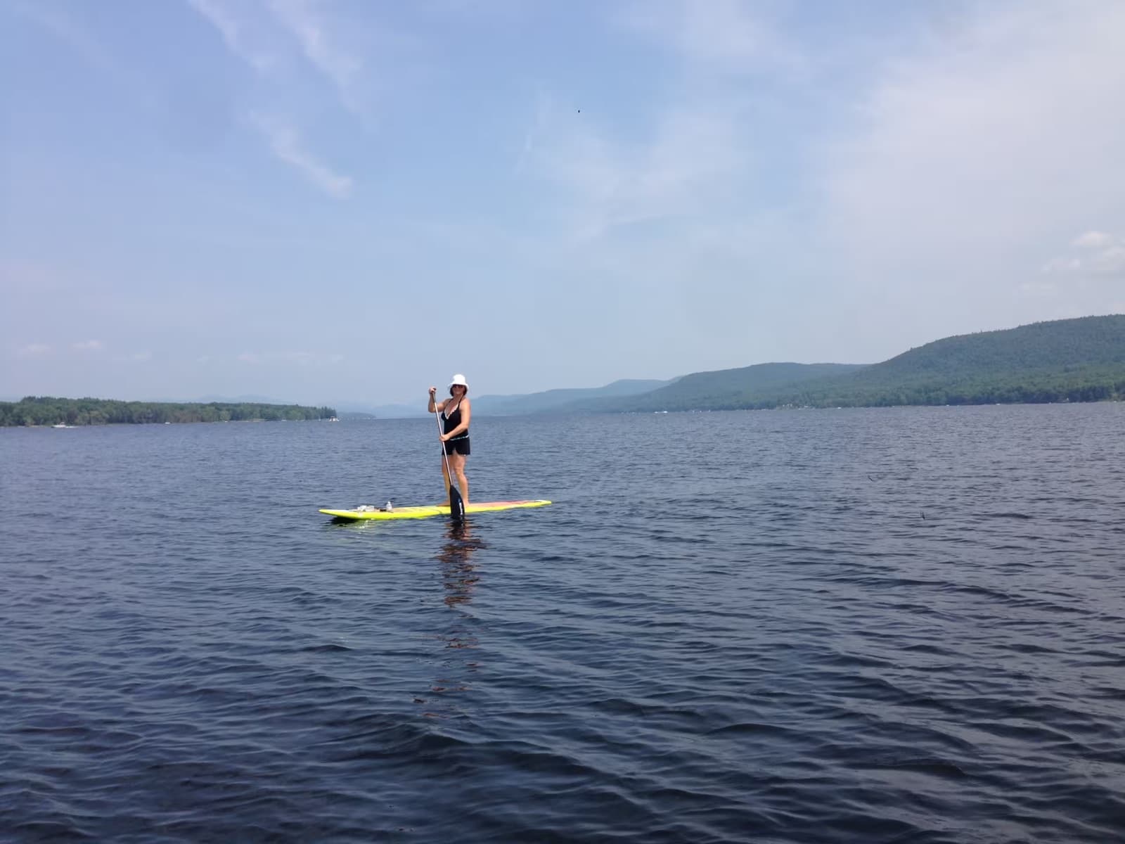 Stand-up paddleboarding on the calm lake